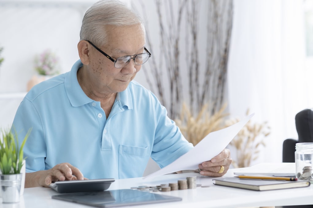 Senior man calculating estate taxes